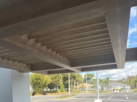 Underside view of a finished custom welded aluminum canopy showing precision slat construction and structural detailing in Fort Myers Florida