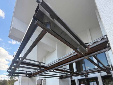 Custom welded aluminum angle attachment detail showing structural canopy framing connection