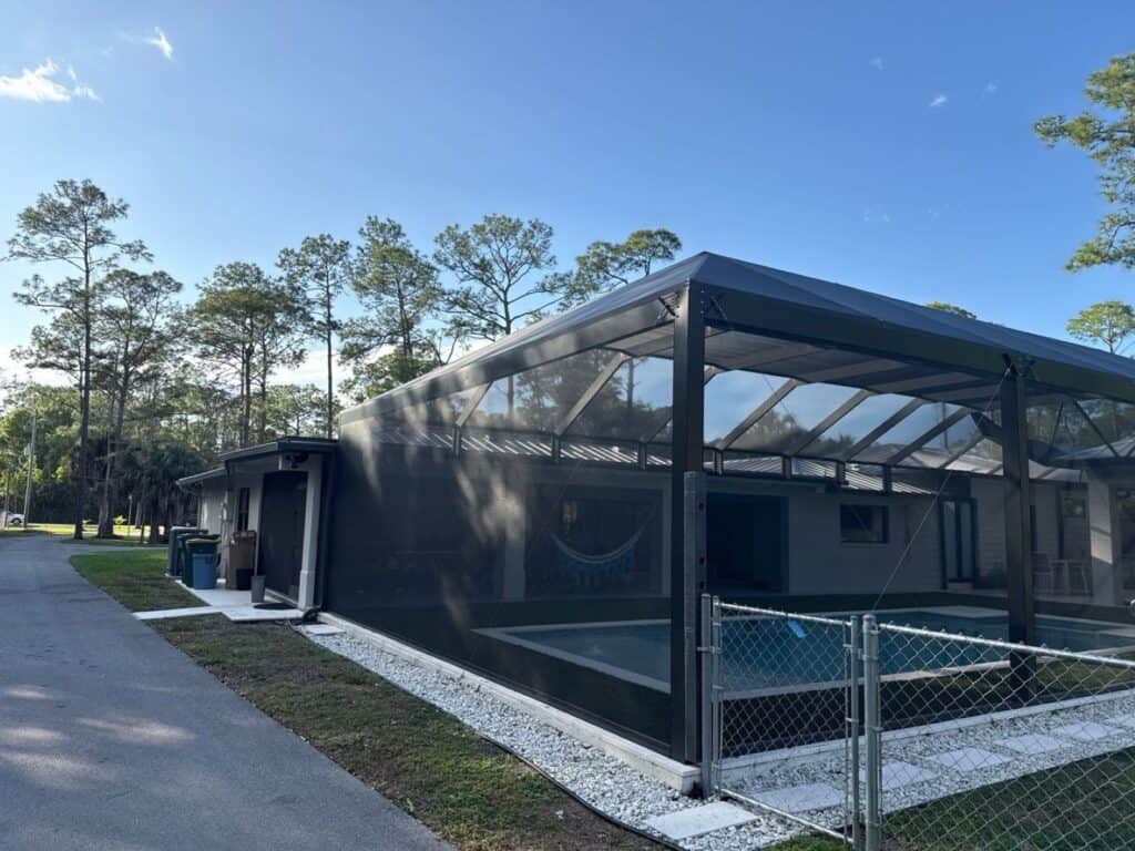 Custom pool screen enclosure with picture windows and transom walls in Bonita Springs, Florida