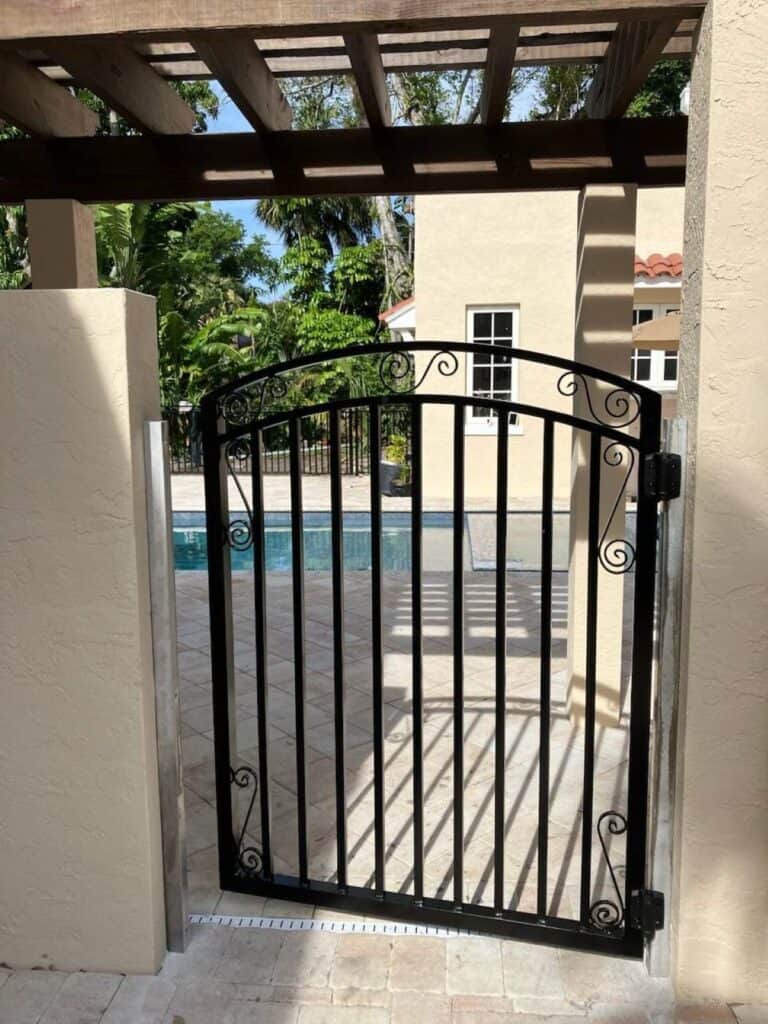 Custom welded aluminum pool safety gate installed at a residential pool area in Florida