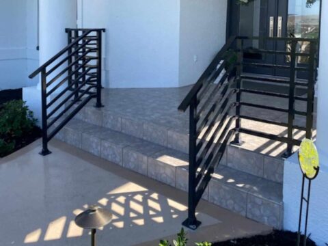 Custom welded aluminum horizontal stair railing installed on residential front entry steps in Fort Myers, Florida