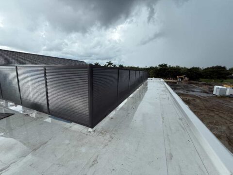 Custom welded aluminum privacy louvers installed on a commercial rooftop for equipment screening and architectural privacy in Florida