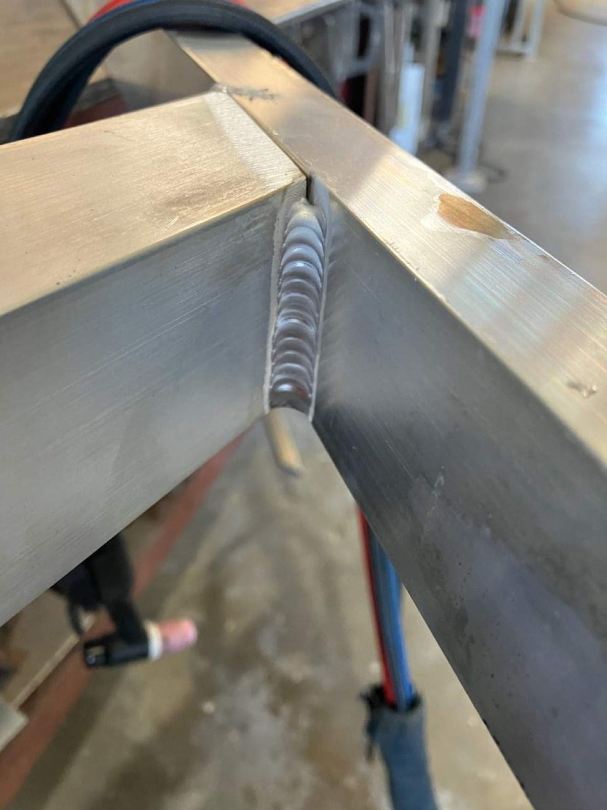 Close-up of precision TIG welded aluminum joint showing clean weld bead on custom aluminum fabrication in Florida