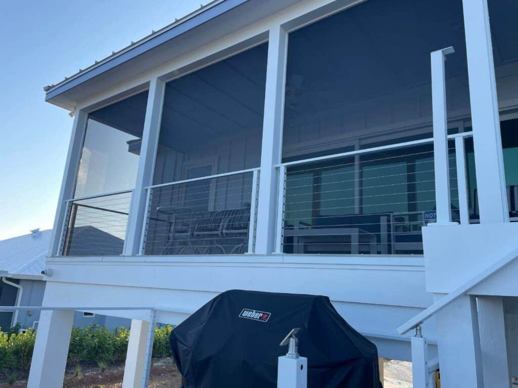 Close-up of stainless steel cable railing installed on a screened porch