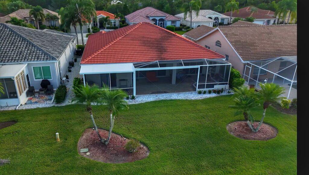 Composite roof gable pool cage enclosure with large front picture window in Heron’s Glen North Fort Myers