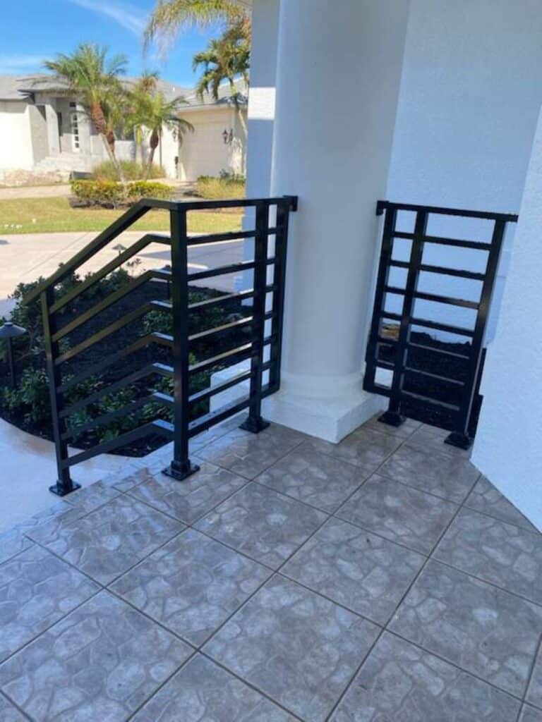 Welded aluminum horizontal railing installed on residential porch in Florida, custom powder-coated aluminum guardrail built to code.