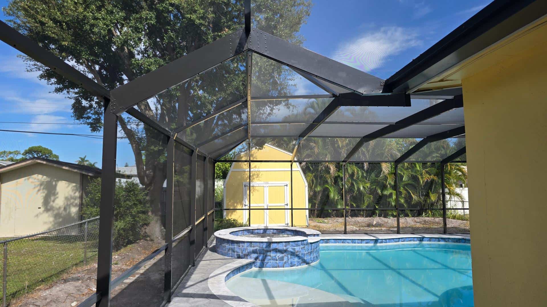 Interior view of Fort Myers pool enclosure with black aluminum framing