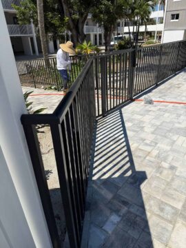 Structural Aluminum employee leveling the railing during the installation.