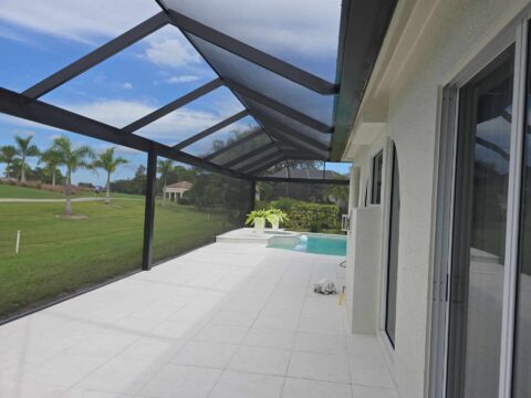 Covered patio under aluminum screen enclosure Naples Florida