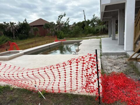 Residential pool and elevated coastal home before screen enclosure installation Sanibel Island Florida