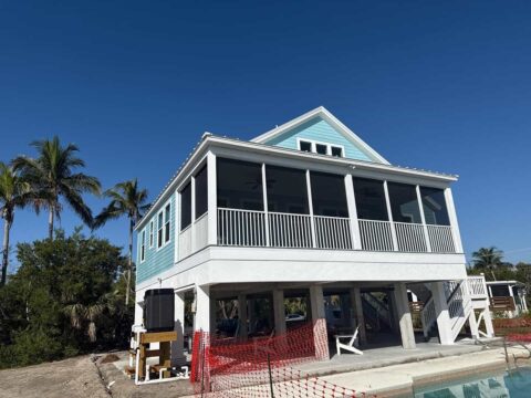 Second floor screen enclosure and aluminum railing on elevated coastal home Sanibel Island Florida