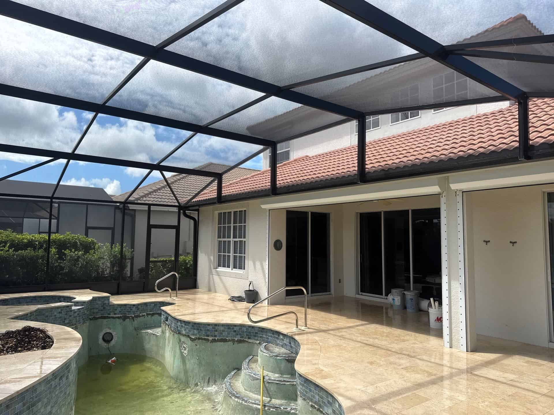 Existing mansard pool screen enclosure before replacement at a Bonita Springs home