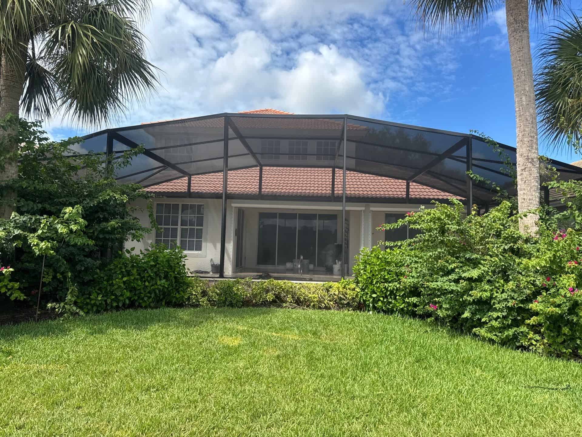Exterior view of a completed bronze dome pool cage in Bonita Springs Florida